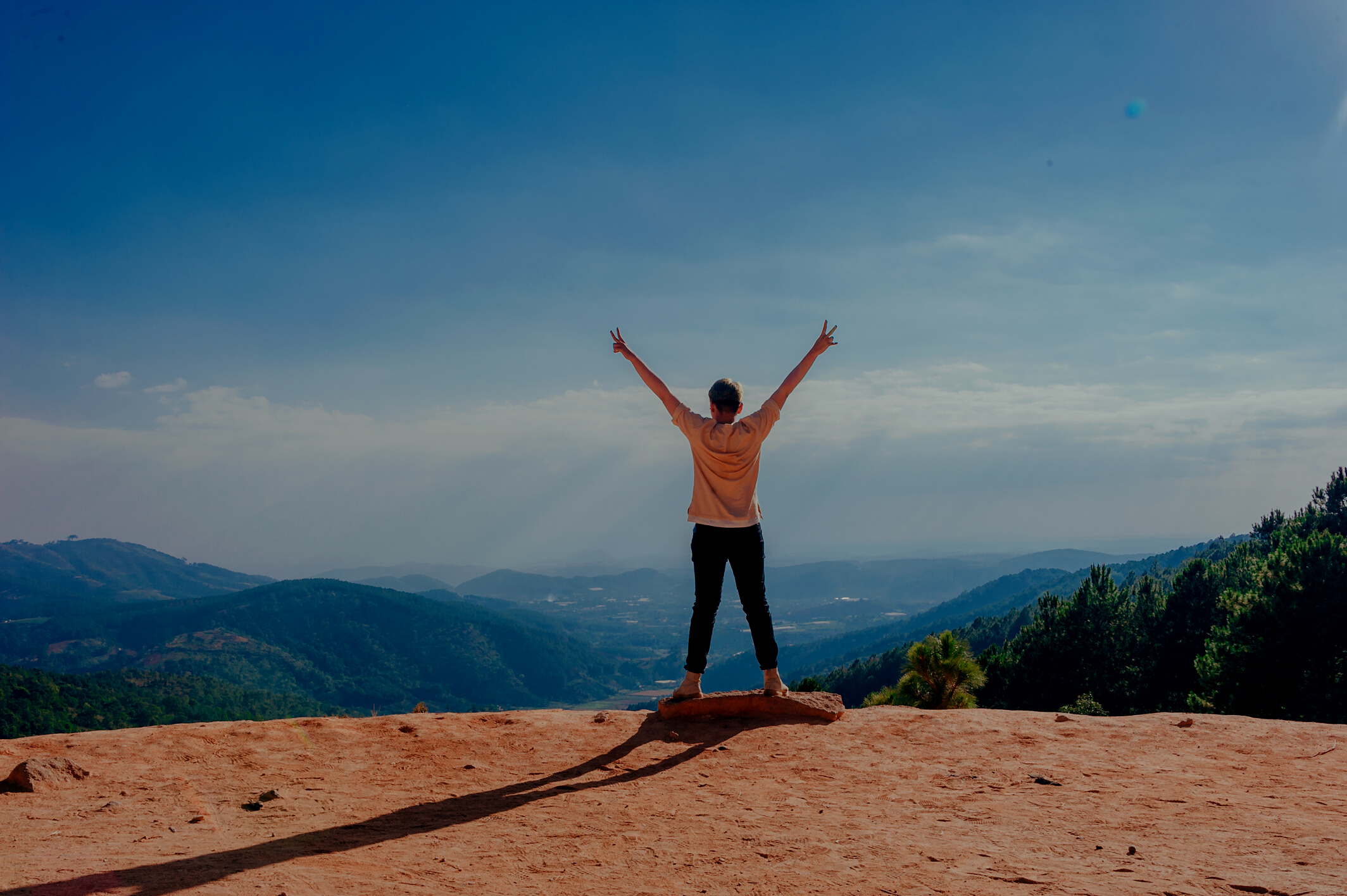 Woman Standing on Cliff